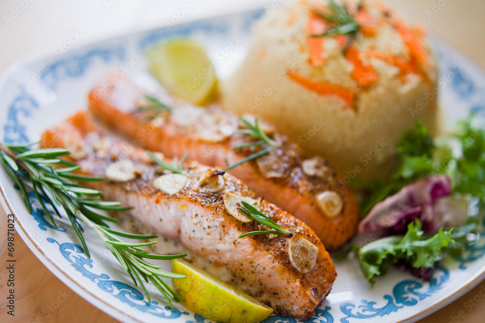 Roasted salmon fish with garlic fresh lettuce and couscous Roasted salmon fish with garlic fresh lettuce and couscous