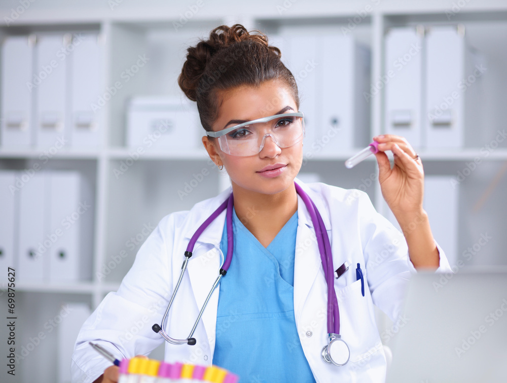 Woman researcher is surrounded by medical vials and flasks, Woman researcher is surrounded by medical vials and flasks,