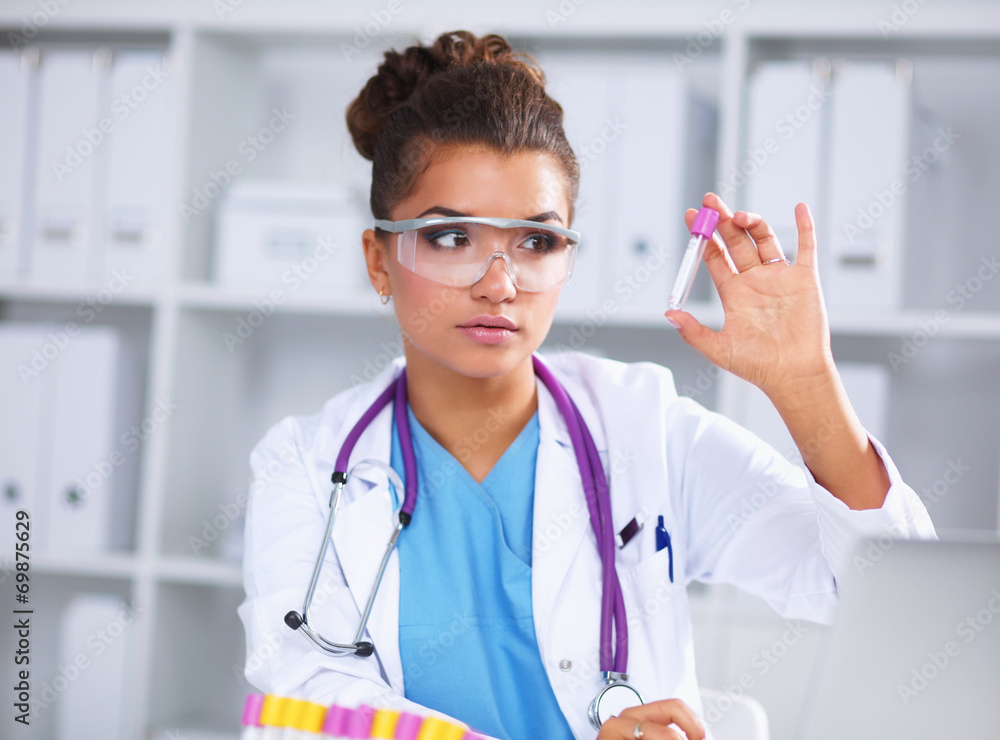 Woman researcher is surrounded by medical vials and flasks, Woman researcher is surrounded by medical vials and flasks,