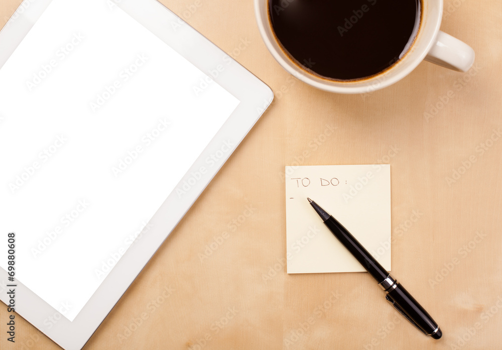 Tablet pc with empty space and a cup of coffee on a desk Tablet pc with empty space and a cup of coffee on a desk