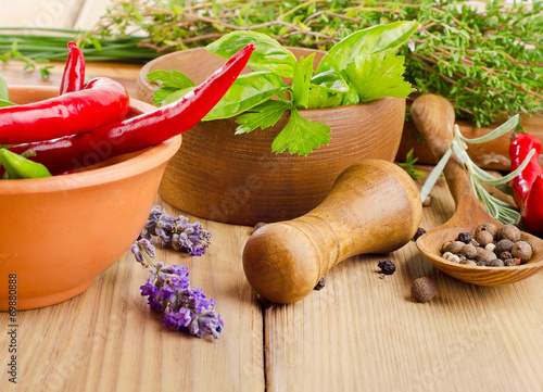 Herbs and peppers on a wooden background