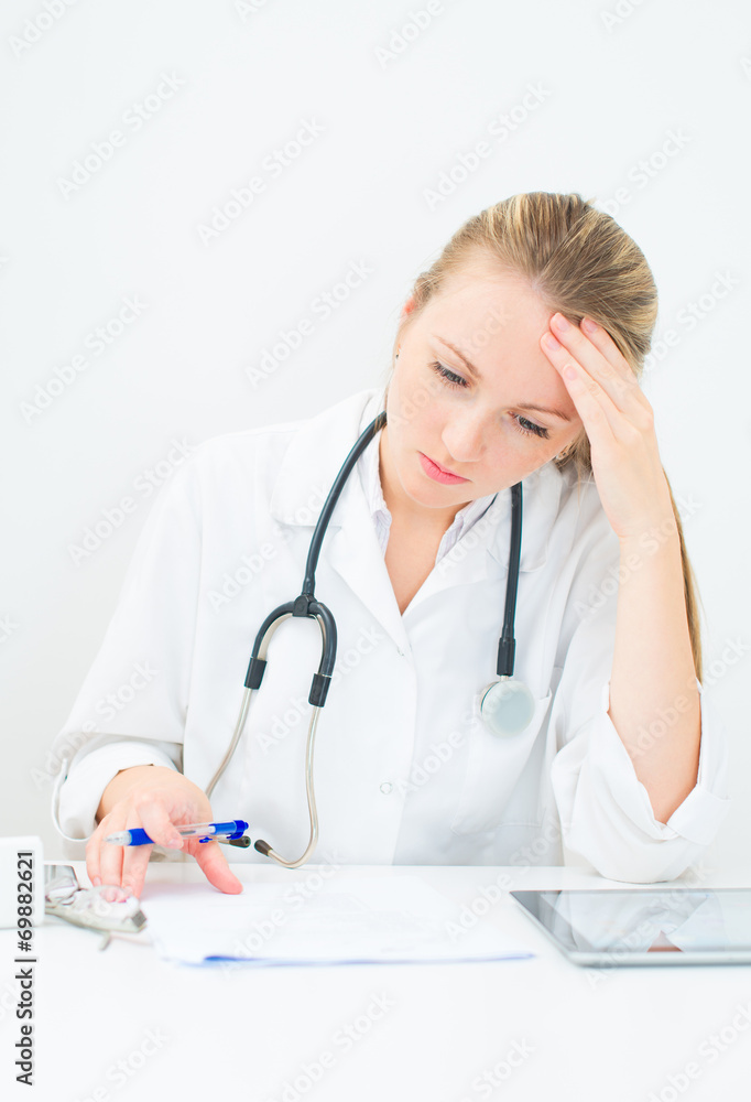 Portrait of female doctor tired from working. Portrait of female doctor tired from working.