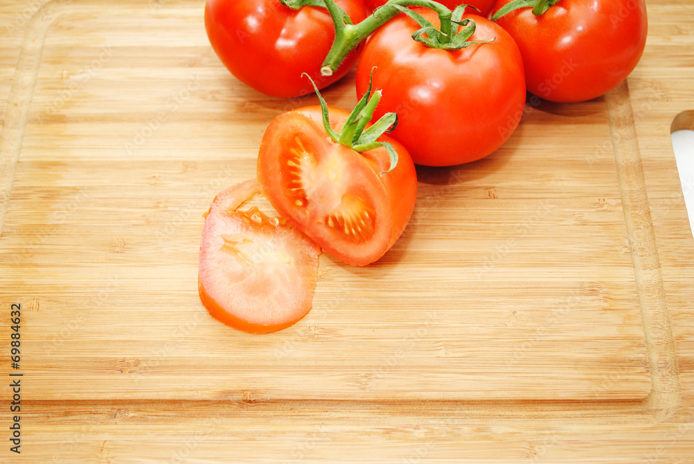 Fresh Organic Tomatoes on a Wooden Cutting Board Fresh Organic Tomatoes on a Wooden Cutting Board