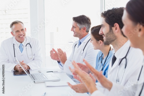 Doctors applauding a fellow doctor