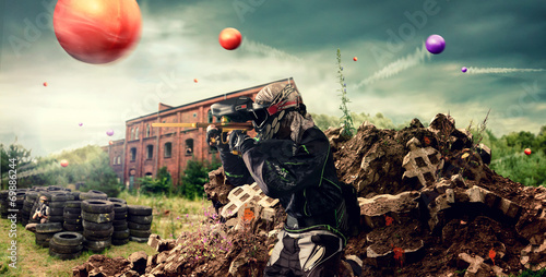 paintballer in action behind cover photo