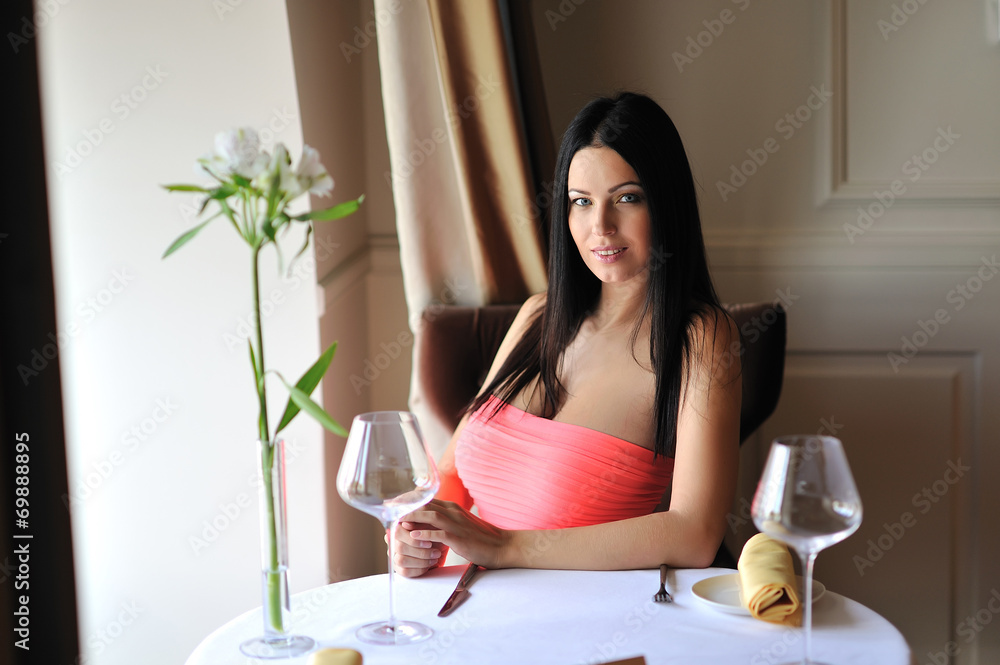 Beautiful brunette young woman sitting at the restaurant Beautiful brunette young woman sitting at the restaurant