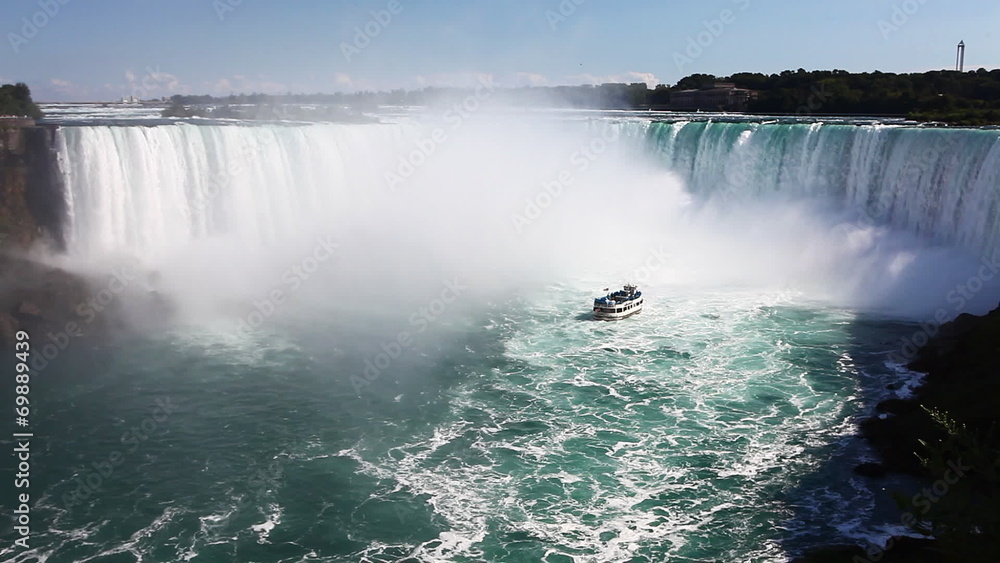 Below Niagara Falls with a tour boat in the spray Below Niagara Falls with a tour boat in the spray