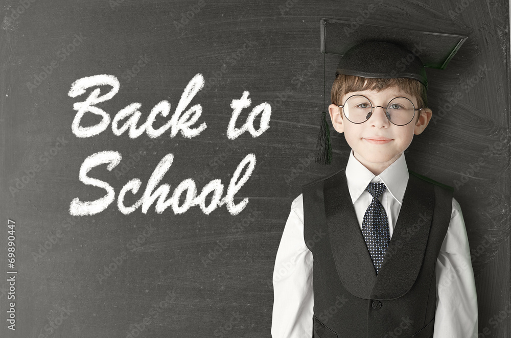 Cheerful little boy on blackboard. Looking at camera Cheerful little boy on blackboard. Looking at camera