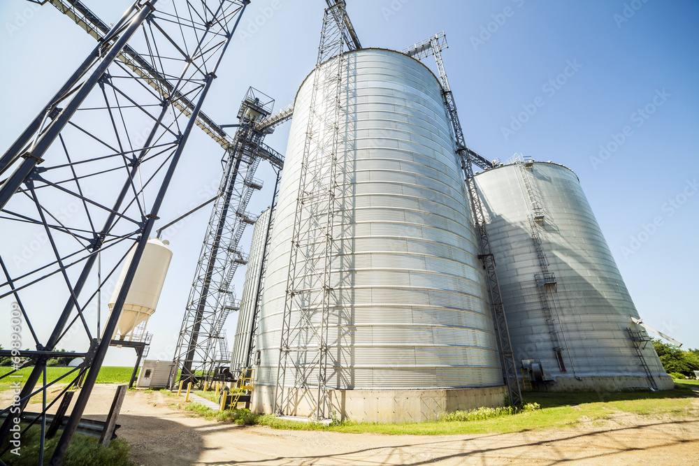 Silver, shiny agricultural silos Silver, shiny agricultural silos