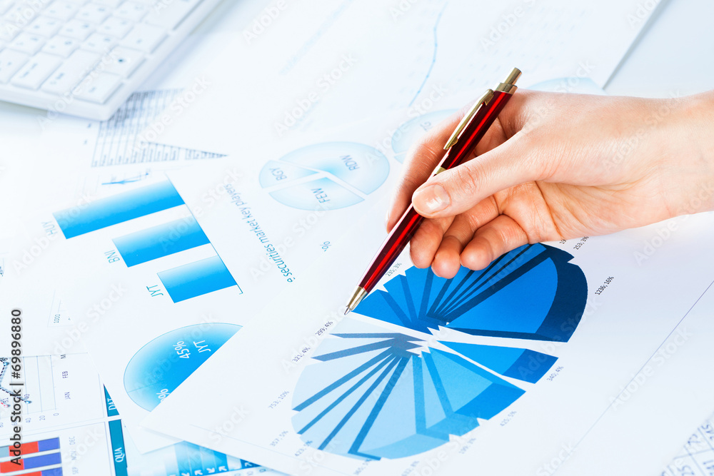 female hand pointing to the financial growth chart female hand pointing to the financial growth chart