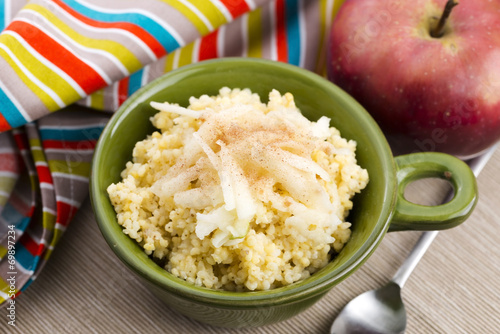 Portion of sweet millet porridge with apple and cinnamon