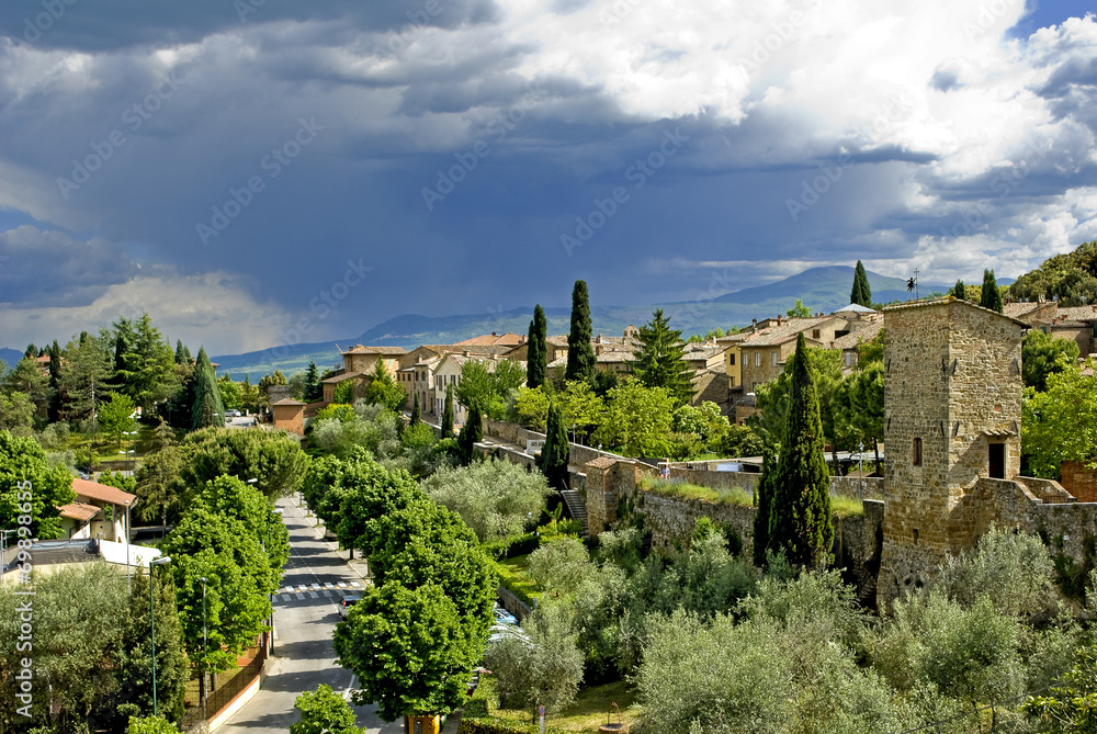A large rain cloud looming over the city of San Quirico d 'Orcia