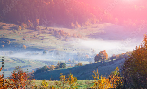 Foggy autumn morning in the mountain village.