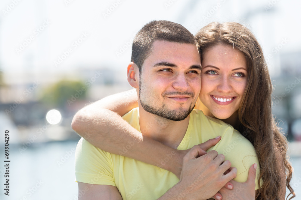 Fototapeta premium Couple taking sunbath on the pier