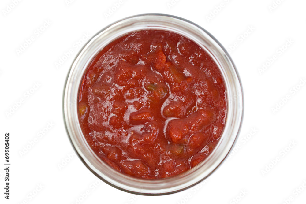 Closeup of a chunky salsa sauce in a glass jar, isolated Closeup of a chunky salsa sauce in a glass jar, isolated