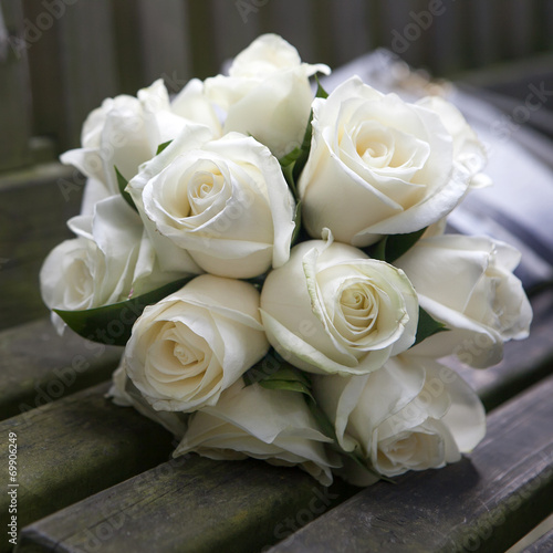 Wedding roses bouquet on wooden bench