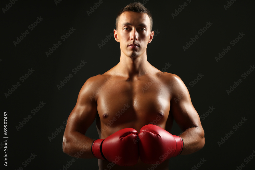Handsome young muscular sportsman with boxing gloves Handsome young muscular sportsman with boxing gloves