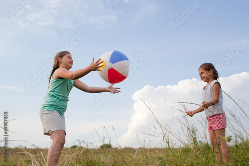Young girls playing with a ball outdoors