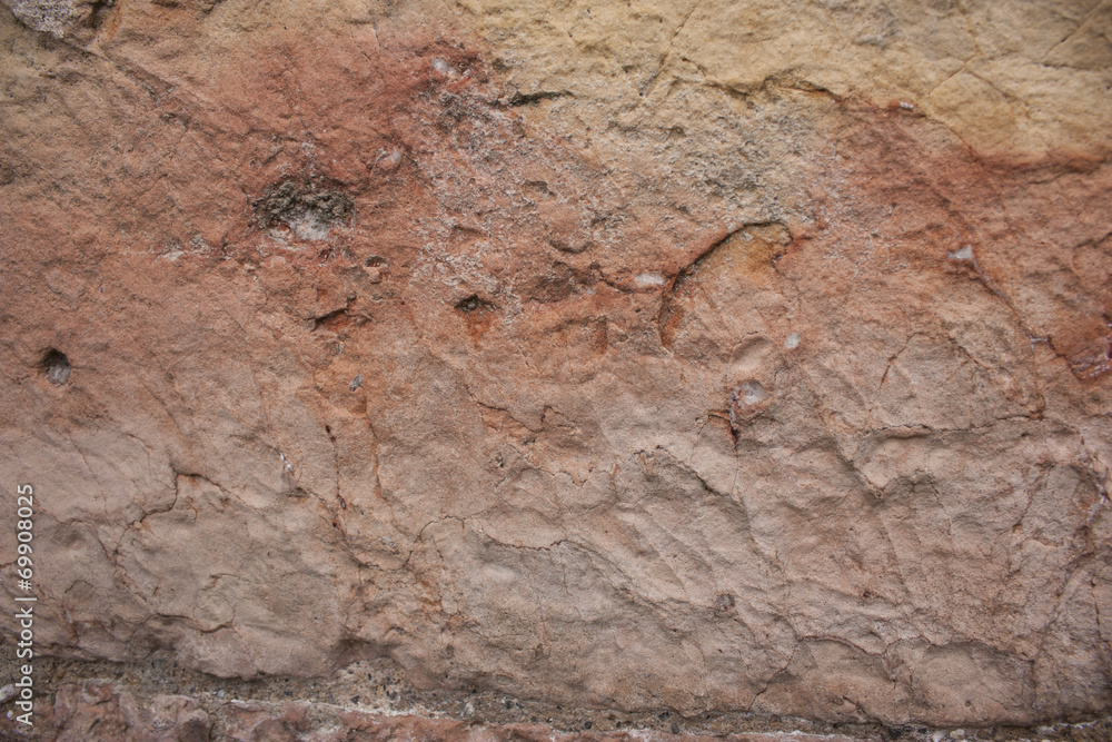 Rough rock background texture with orange and slight pink tints Rough rock background texture with orange and slight pink tints