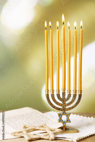 Menorah, star of David and page of Genesis book photo