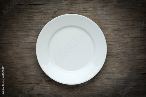 Empty  white plate on wooden background