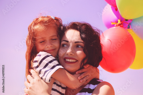 Happy mom and daughter with...