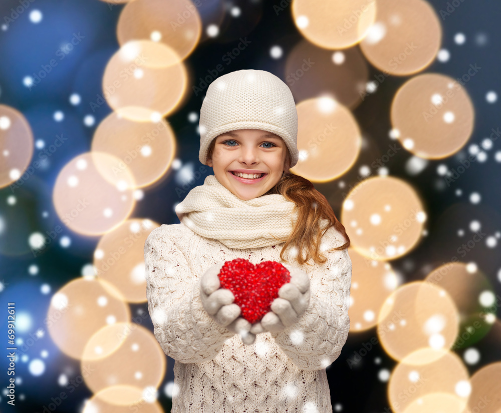 girl in winter clothes with small red heart girl in winter clothes with small red heart