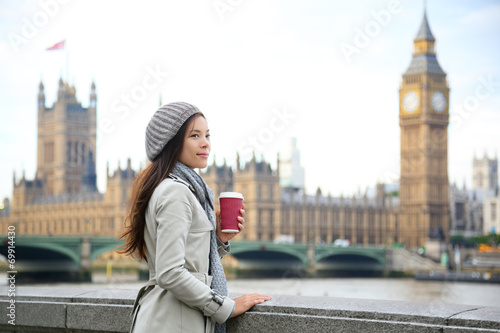 London woman drinking coffee by Westminster Bridge