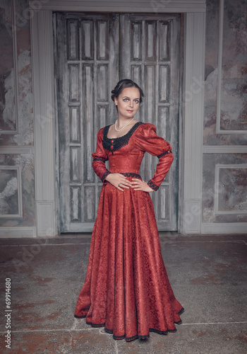 Beautiful woman in red long medieval dress