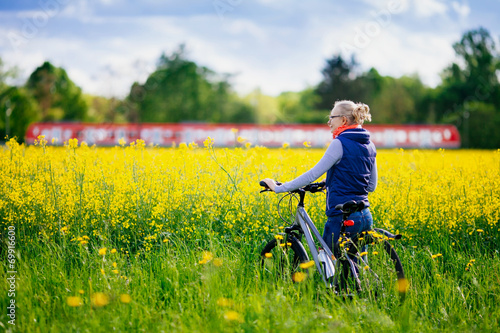 Girl with bike in meadow