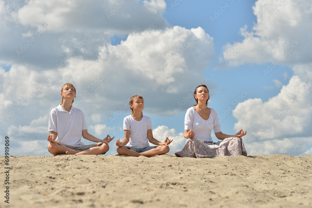 family meditate over blue cloudy