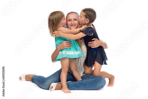 two daughters kiss mom