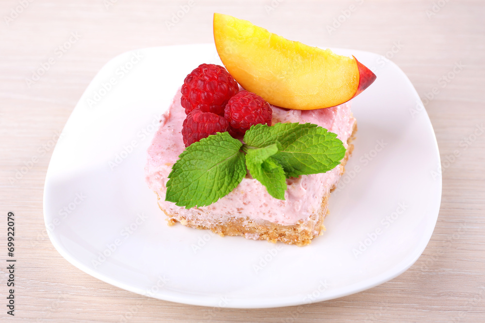 Cake with fruits and berries on plate on wooden background Cake with fruits and berries on plate on wooden background
