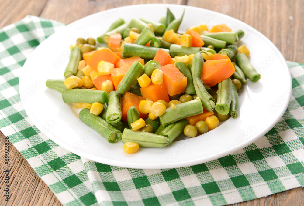 Delicious vegetables salad on plate on table close-up Delicious vegetables salad on plate on table close-up