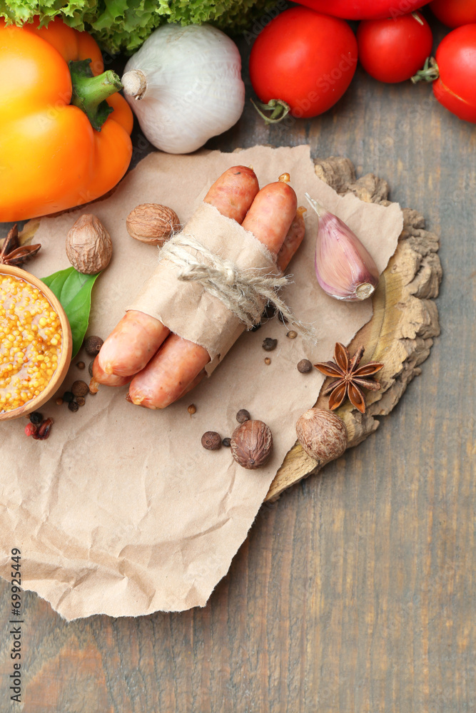 Composition of thin sausages, mustard in bowl and spices Composition of thin sausages, mustard in bowl and spices