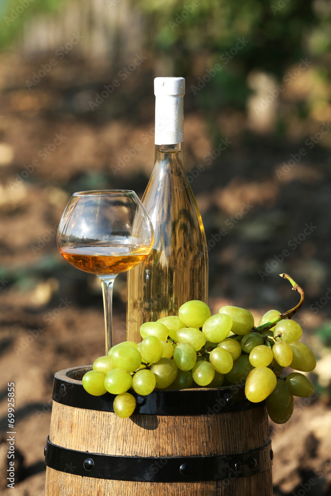 Wooden barrel, grape and bottle of wine