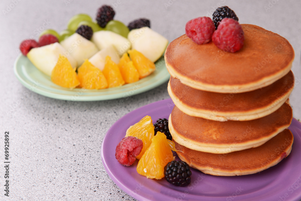 Pancake with fruits and berries on plate on table close up Pancake with fruits and berries on plate on table close up
