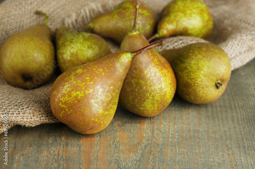Ripe pears on wooden background