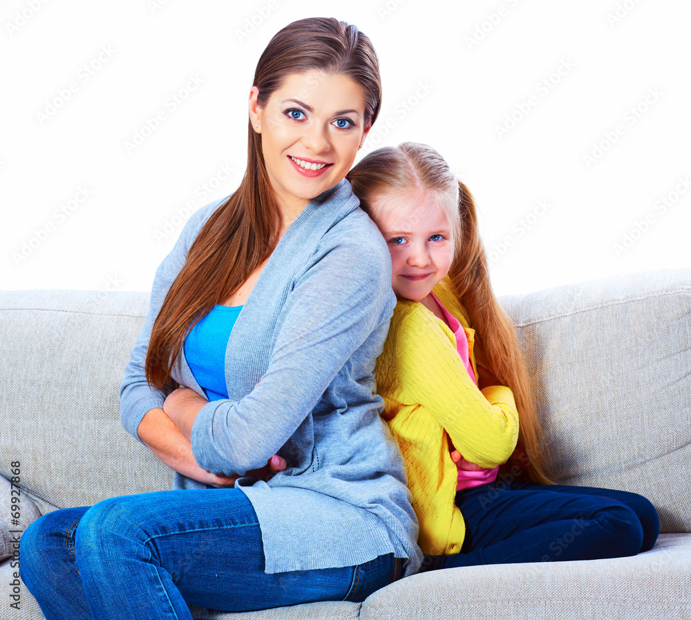Mother with daughter seat on sofa back to back. Mother with daughter seat on sofa back to back.