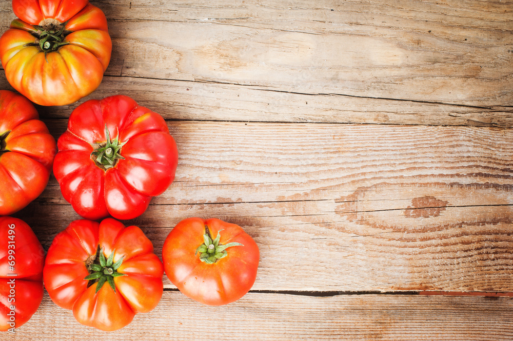Red big tomatoes on a wooden rustic table in a beautiful day Red big tomatoes on a wooden rustic table in a beautiful day