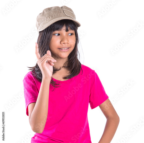 Young preteen Asian girl with a cap over white background © akulamatiau