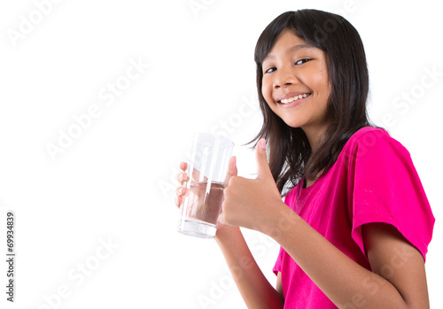 Young Asian preteen with a glass of water over white background