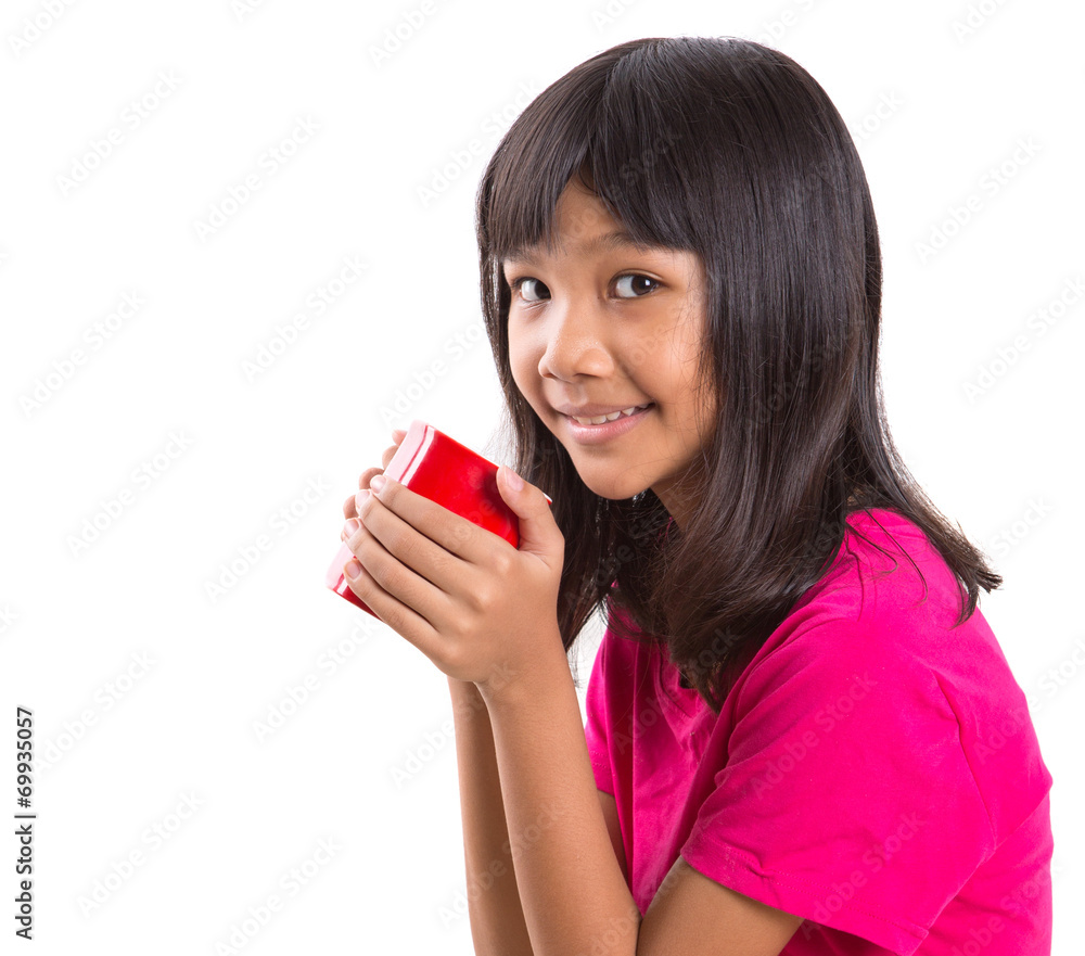 Young Asian preteen girl with a red mug over white background Young Asian preteen girl with a red mug over white background