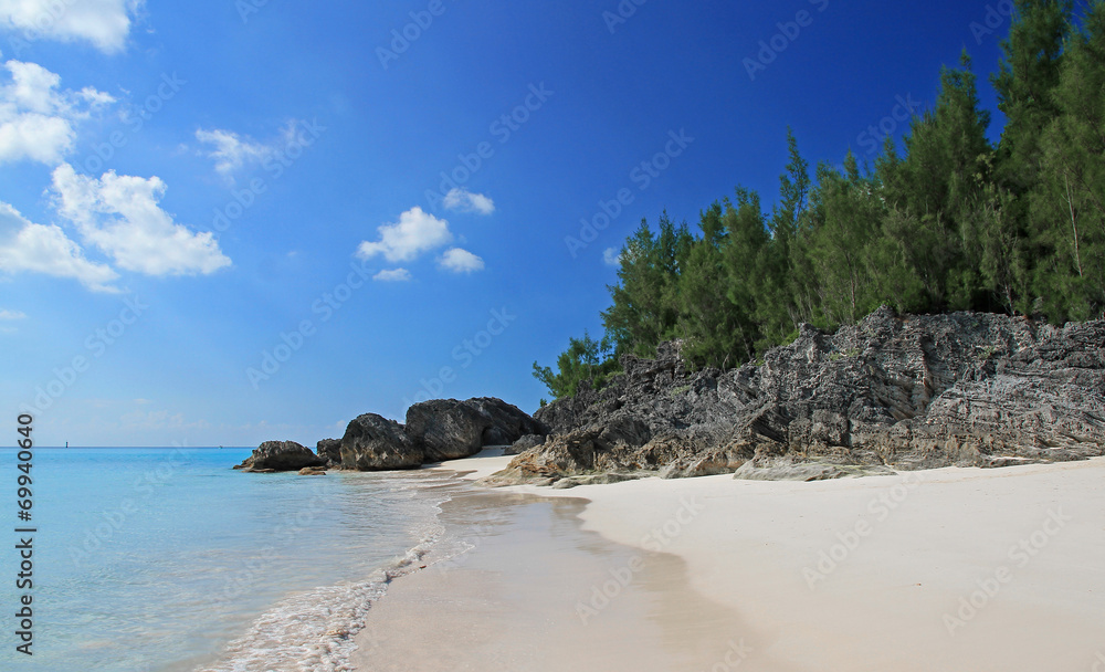 Fototapeta premium A tropical beach, with a clear blue sea, on a summers day
