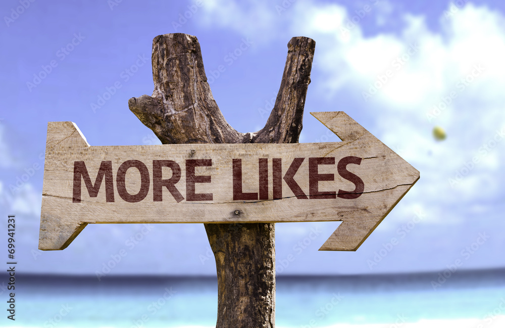 More Likes wooden sign with a beach on background