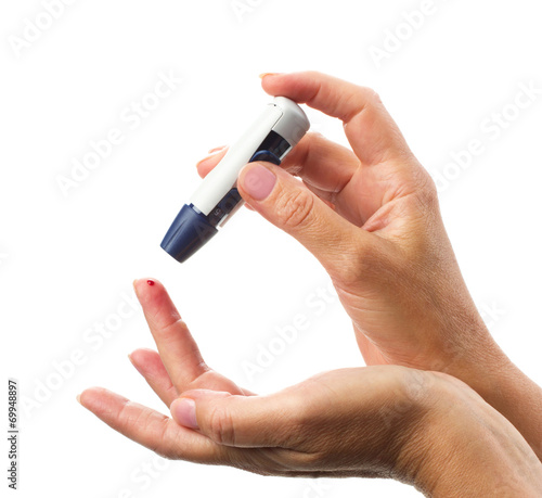 glucometer's  stick  in woman hand