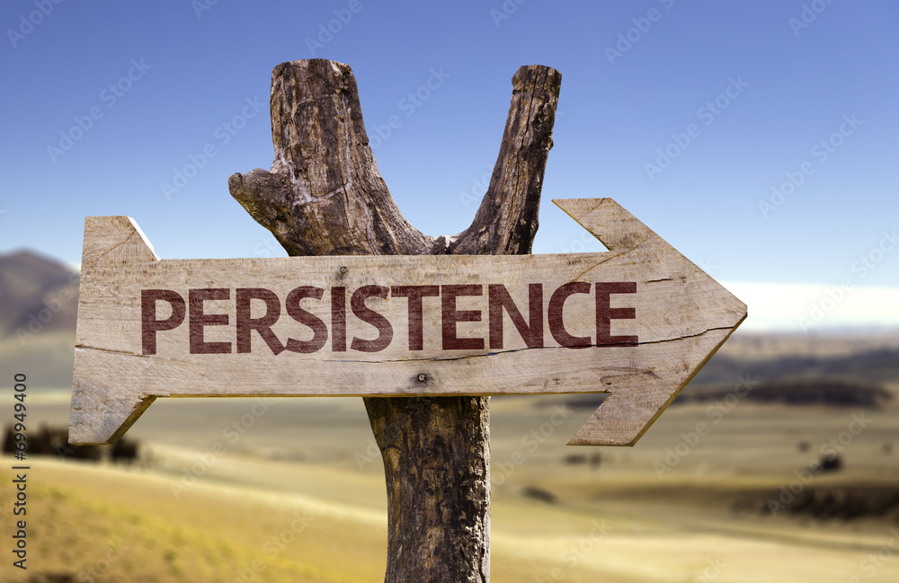 Persistence wooden sign with a desert background
