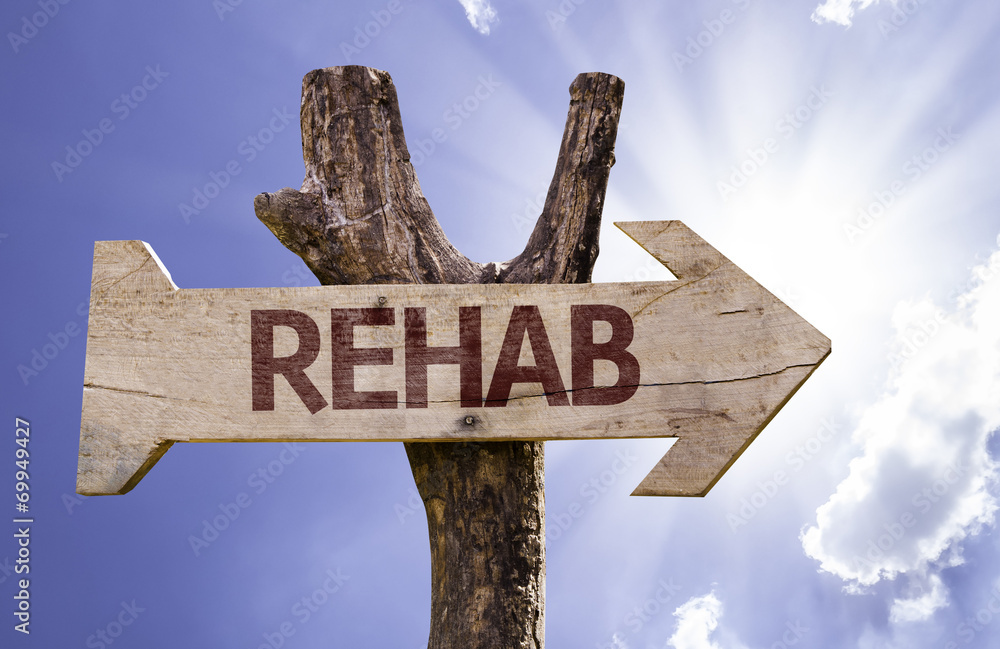 Rehab wooden sign on a beautiful day