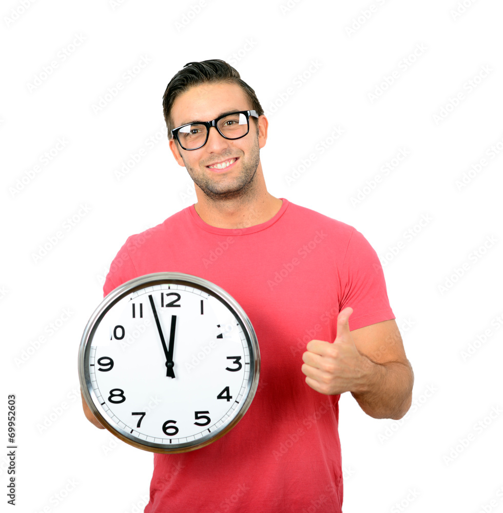 Happy young handsome man holding clock in his hand with thumb up Happy young handsome man holding clock in his hand with thumb up