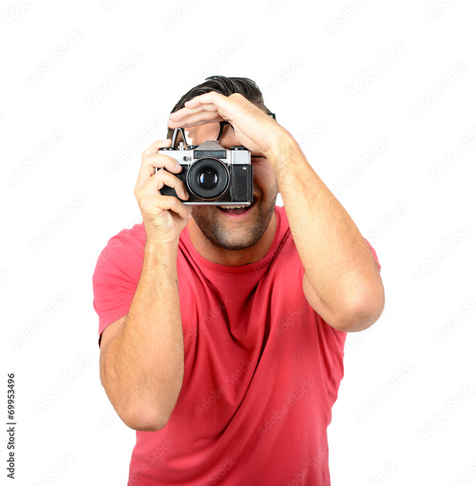 Young man using a retro camera against white background Young man using a retro camera against white background